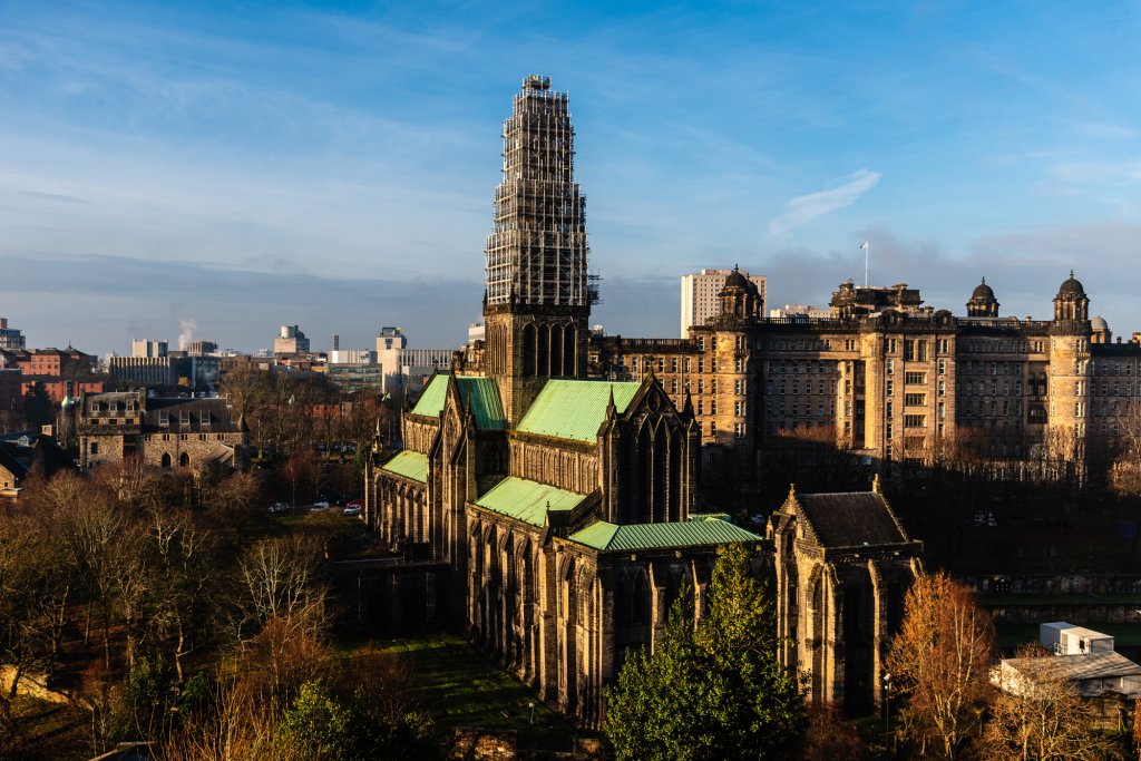 The iconic Glasgow Cathedral on a sunny day with scaffolding around the top.