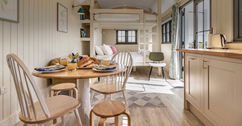 A table is laid for breakfast inside the cosy Bankhead Shepherd's Hut in Scotland.