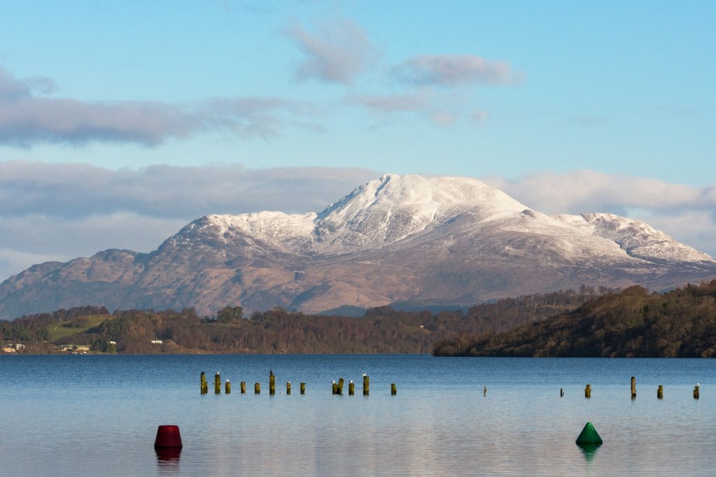 The snow mountain view of Ben Nevis from the riverside.