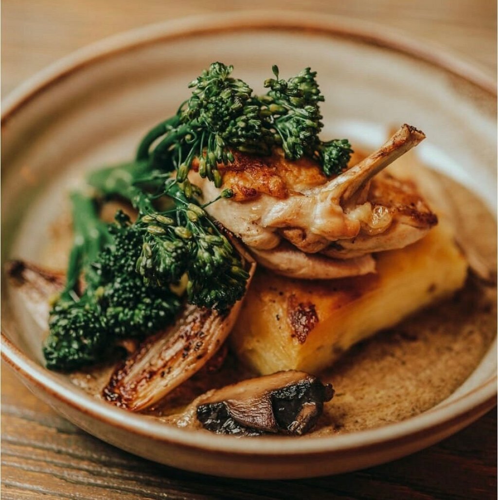 A very well cooked duck breast sits on a very neat dough from my potato with stem broccoli, mushrooms and shallots onions.