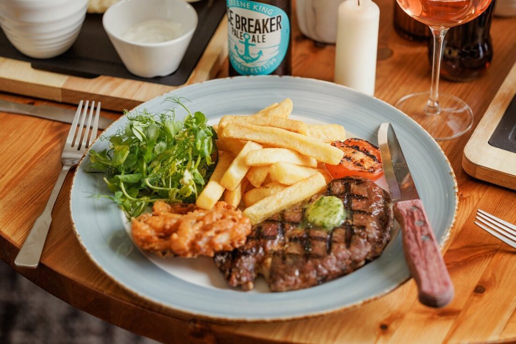A plate of steak and chips.