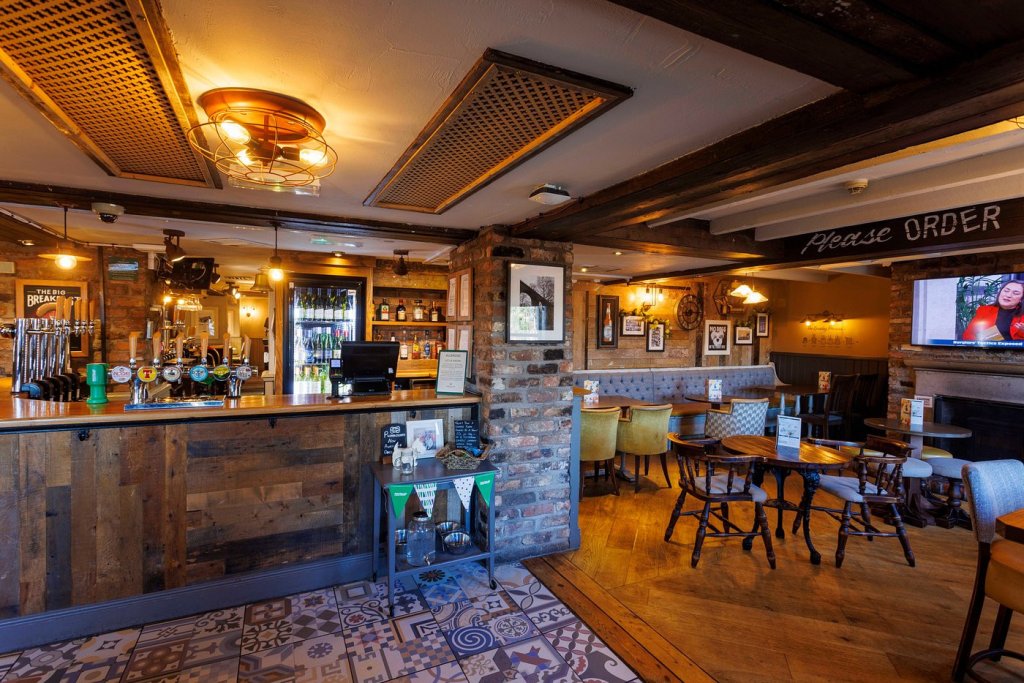play interior shots of the bell tree pub showing wooden floor and exposed beams and brickwork.